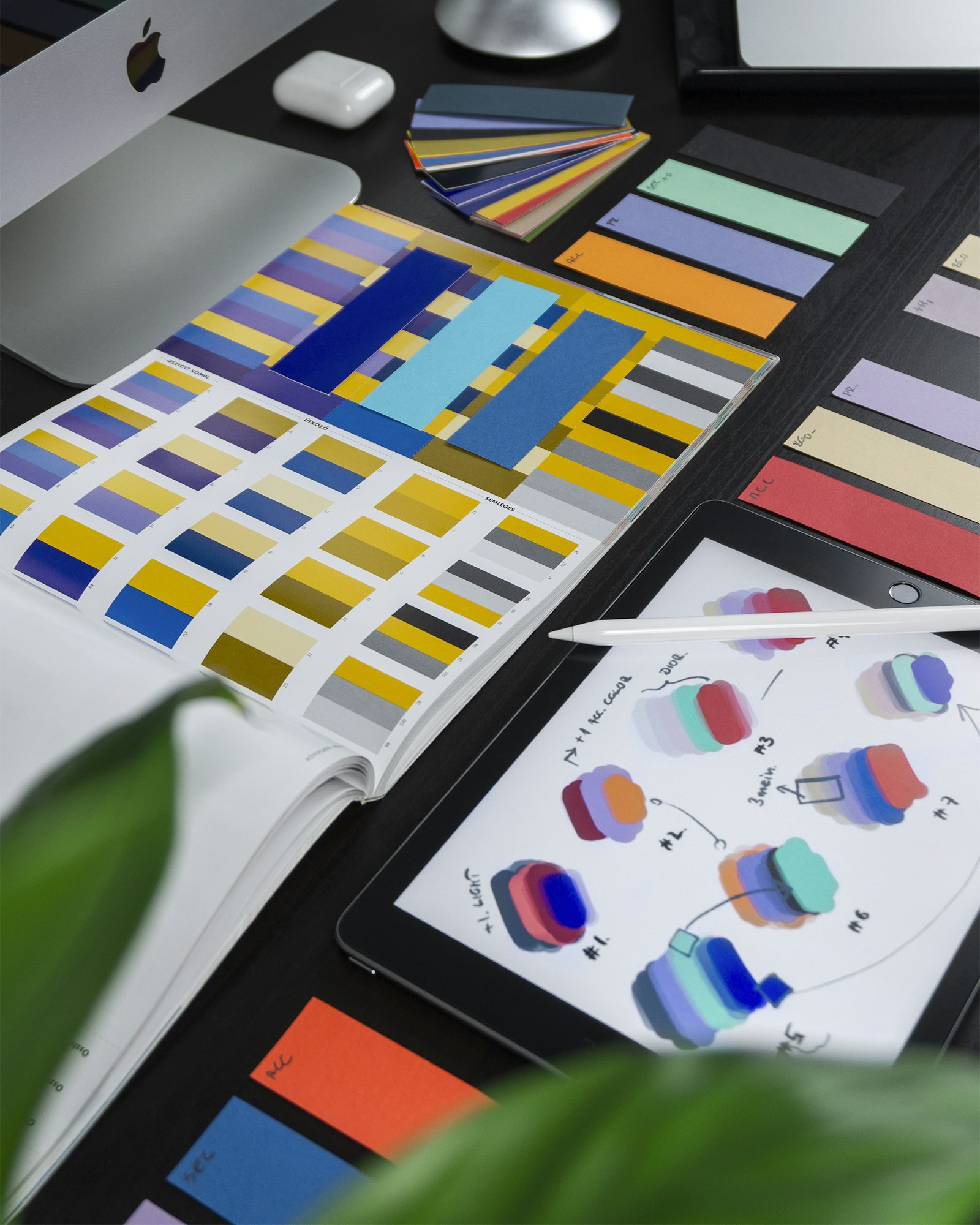 Brand design materials and color swatches on a desk
